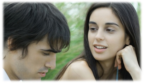 Young couple, woman looking at man, man looking down, head and shoulders